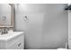 Bright bathroom featuring a vanity with a single sink, a framed mirror, and a towel ring, providing simple functionality at 5024 Starfinder Ave, Las Vegas, NV 89108