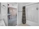 Functional bathroom with a bathtub-shower combo, complemented by a view into a bedroom with an office space at 5024 Starfinder Ave, Las Vegas, NV 89108