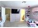 Spacious bedroom with TV, bath access, and storage at 5024 Starfinder Ave, Las Vegas, NV 89108
