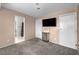 Bedroom showcasing plush carpeting, a TV, and convenient access to an adjacent bathroom at 5024 Starfinder Ave, Las Vegas, NV 89108