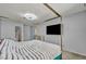 Bedroom featuring a four-poster bed, TV, and modern light fixture at 5024 Starfinder Ave, Las Vegas, NV 89108