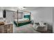 Cozy bedroom with a four-poster bed, soft chair, and modern decor at 5024 Starfinder Ave, Las Vegas, NV 89108