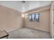 A cozy bedroom with neutral carpet, a small window, and a lamp, providing a calming ambiance at 5024 Starfinder Ave, Las Vegas, NV 89108