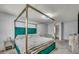 Comfortable bedroom featuring a green canopy bed and a stylish nightstand, creating a cozy and inviting space at 5024 Starfinder Ave, Las Vegas, NV 89108
