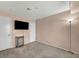 Cozy bedroom with plush carpeting, complemented by a TV and convenient access to two entryways at 5024 Starfinder Ave, Las Vegas, NV 89108
