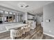 Bright dining area with modern table, chairs, and decorative mirrors, adjacent to the kitchen with wood floors at 5024 Starfinder Ave, Las Vegas, NV 89108