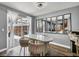 Cozy dining area with a white table, stylish chairs, and sliding glass door, bringing in natural light at 5024 Starfinder Ave, Las Vegas, NV 89108