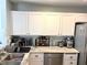 Bright kitchen with white cabinetry, stainless steel appliances and a stylish backsplash at 5024 Starfinder Ave, Las Vegas, NV 89108