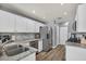 Well-lit kitchen featuring stainless steel appliances, granite countertops, and wood-look flooring at 5024 Starfinder Ave, Las Vegas, NV 89108