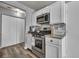Bright kitchen with white cabinetry, stainless steel appliances, and wood-look flooring at 5024 Starfinder Ave, Las Vegas, NV 89108
