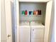 Efficient laundry closet with white washer and dryer plus storage shelf at 5024 Starfinder Ave, Las Vegas, NV 89108