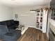 Comfortable living room features a plush sectional, modern shelving and hardwood floors at 5024 Starfinder Ave, Las Vegas, NV 89108