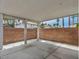 Covered patio with a brick wall, concrete pavers, and palm tree views at 5024 Starfinder Ave, Las Vegas, NV 89108
