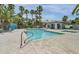 Community pool featuring clear blue water, palm trees, and a pool-side cabana at 5024 Starfinder Ave, Las Vegas, NV 89108