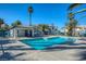 Community pool with clear blue water and shade, surrounded by palm trees and well-maintained landscaping at 5024 Starfinder Ave, Las Vegas, NV 89108