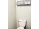 Toilet with white porcelain and metal storage shelf above at 5024 Starfinder Ave, Las Vegas, NV 89108