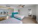 Bedroom with hardwood floors and two beds, one of which has a turquoise headboard and a mirrored closet at 530 Tam O Shanter, Las Vegas, NV 89109