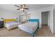 Bright bedroom featuring two beds, ceiling fan, and mirrored closet at 530 Tam O Shanter, Las Vegas, NV 89109
