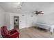 Bright bedroom featuring hardwood floors, a ceiling fan, track lights, and a red chair at 530 Tam O Shanter, Las Vegas, NV 89109
