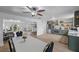 Dining room featuring a white table, access to the kitchen, living room and outdoor view at 530 Tam O Shanter, Las Vegas, NV 89109