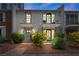 Inviting townhome featuring dual balconies, a brick pathway, blossoming shrubs, and exterior lighting at 530 Tam O Shanter, Las Vegas, NV 89109