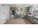 Charming kitchen featuring stainless steel appliances, shaker style cabinets and an island sink at 530 Tam O Shanter, Las Vegas, NV 89109