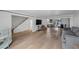 Spacious living room featuring hardwood floors, stairs, flatscreen tv and access to the updated kitchen at 530 Tam O Shanter, Las Vegas, NV 89109