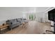 Spacious living room featuring hardwood floors, contemporary furniture, and glass doors to backyard at 530 Tam O Shanter, Las Vegas, NV 89109
