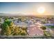 Residential single-story home with mature landscaping, desert landscape and mountain views at sunrise at 5701 Mary Lou St, Pahrump, NV 89061