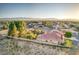 Expansive property featuring a pink tile roof, mature trees, and mountain views in a vibrant community at 5701 Mary Lou St, Pahrump, NV 89061