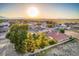 Residential single-story home with mature landscaping, desert landscape and mountain views at sunset at 5701 Mary Lou St, Pahrump, NV 89061