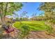 A spacious back yard with mature trees and green grass is ready for entertaining at 5701 Mary Lou St, Pahrump, NV 89061