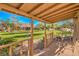 Scenic backyard view from the covered porch, showcasing the lush lawn and landscaping at 5701 Mary Lou St, Pahrump, NV 89061