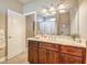 Full bathroom with a wood vanity cabinet, a framed mirror, and a shower with decorative curtain at 5701 Mary Lou St, Pahrump, NV 89061