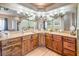 Bathroom features a wide mirror, wood cabinets, and stylish lighting fixtures at 5701 Mary Lou St, Pahrump, NV 89061
