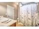 Full bathroom featuring neutral colors, vanity with sink, toilet, and decorative shower curtain at 5701 Mary Lou St, Pahrump, NV 89061