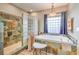 Bathroom featuring a shower, bathtub, and vanity area lit by a stylish light fixture at 5701 Mary Lou St, Pahrump, NV 89061