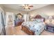 Nicely decorated bedroom with a ceiling fan, wood floors, and well-placed lighting at 5701 Mary Lou St, Pahrump, NV 89061