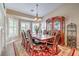 Elegant dining room with ample seating, a grand china cabinet, and a chandelier at 5701 Mary Lou St, Pahrump, NV 89061
