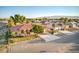 Charming single-story home with a well-maintained lawn, desert landscaping and terra cotta colored tile roof at 5701 Mary Lou St, Pahrump, NV 89061