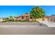 A single story home with a terra cotta colored roof, arched entryway and mature landscaping at 5701 Mary Lou St, Pahrump, NV 89061