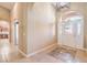 A spacious foyer with neutral colored walls and tile floor featuring mosaic accents and arched doorways at 5701 Mary Lou St, Pahrump, NV 89061