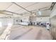 Spacious garage interior featuring ample storage, utility equipment, and a pet kennel area at 5701 Mary Lou St, Pahrump, NV 89061