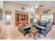 An open concept living room with custom built-ins, a fireplace, and neutral colored walls at 5701 Mary Lou St, Pahrump, NV 89061