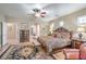Cozy primary bedroom with an ornate bed, accent rug, and natural light from windows at 5701 Mary Lou St, Pahrump, NV 89061