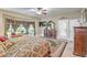 Spacious main bedroom featuring a ceiling fan, tv, and backyard access at 5701 Mary Lou St, Pahrump, NV 89061