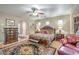 Luxurious primary bedroom with elegant furniture, a ceiling fan, and stylish decor at 5701 Mary Lou St, Pahrump, NV 89061