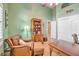 Home office with wood floors, a leather armchair, and built-in storage at 5701 Mary Lou St, Pahrump, NV 89061