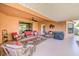 Covered patio with comfortable seating, ceiling fan, and stylish outdoor decor at 5701 Mary Lou St, Pahrump, NV 89061