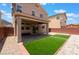 Backyard featuring a covered patio, brick pavers, and turf at 6412 Dimatteo St, Las Vegas, NV 89148